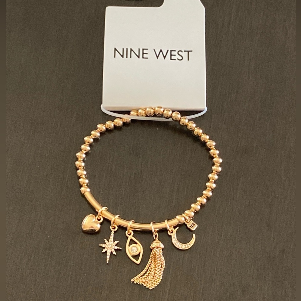Nine West Gold Tone Tassel, Heart. Star, Moon, Evil Eye Charm Stretch Bracelet